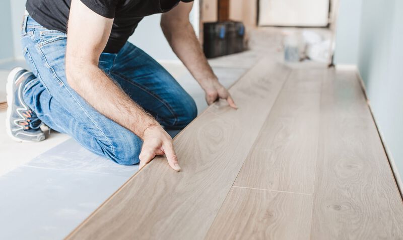 Man installing wood flooring