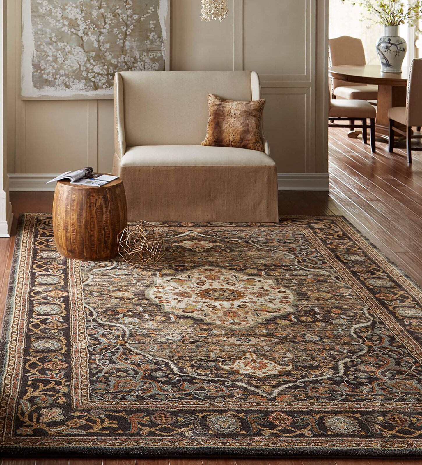 large dark brown and burnt orange area rug laid over a hardwood floor