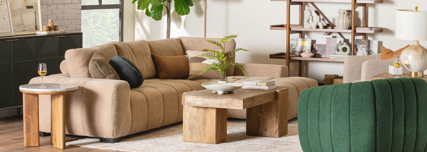 Brightly lit living room with green sofa and chairs