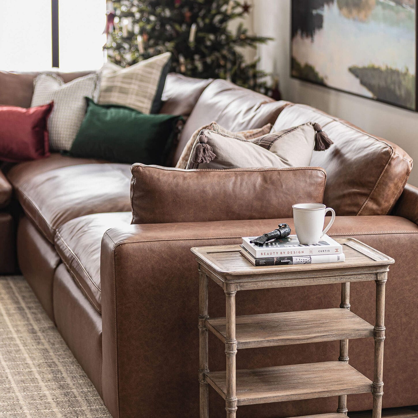 Christmas living room with a leather sofa and a tree in the background