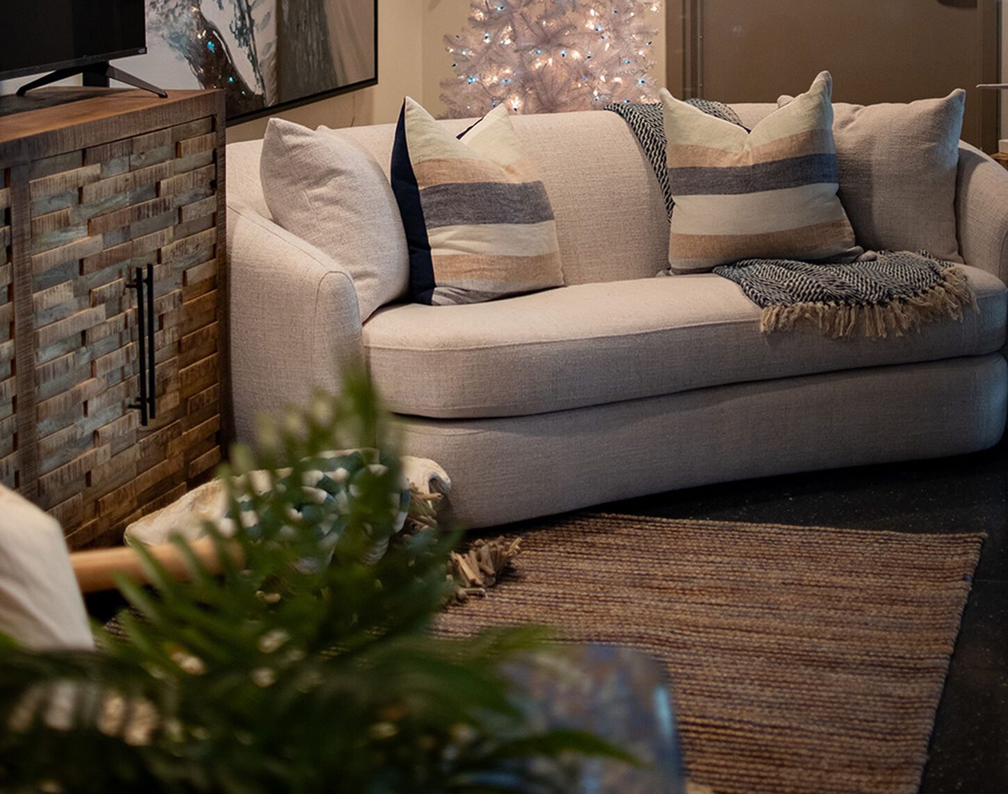 Jewel box at Grandscape with sofa, rug, and TV stand from NFM.