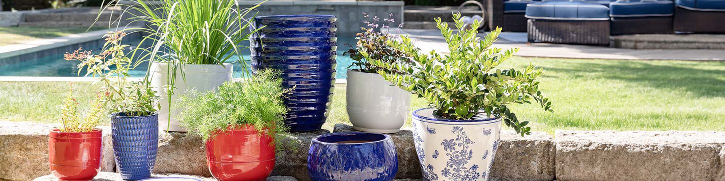 a collection of colorful outdoor pots and planters