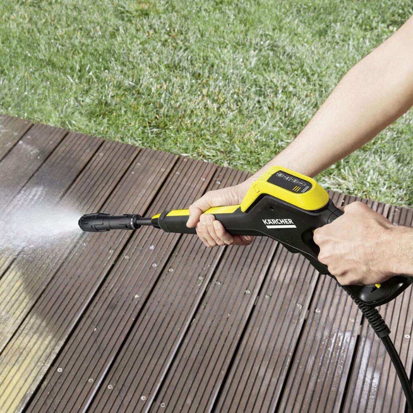 pressure washer washing off a deck