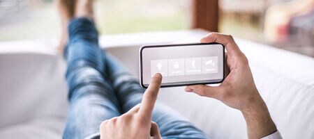 Person using their phone to manage their smart home