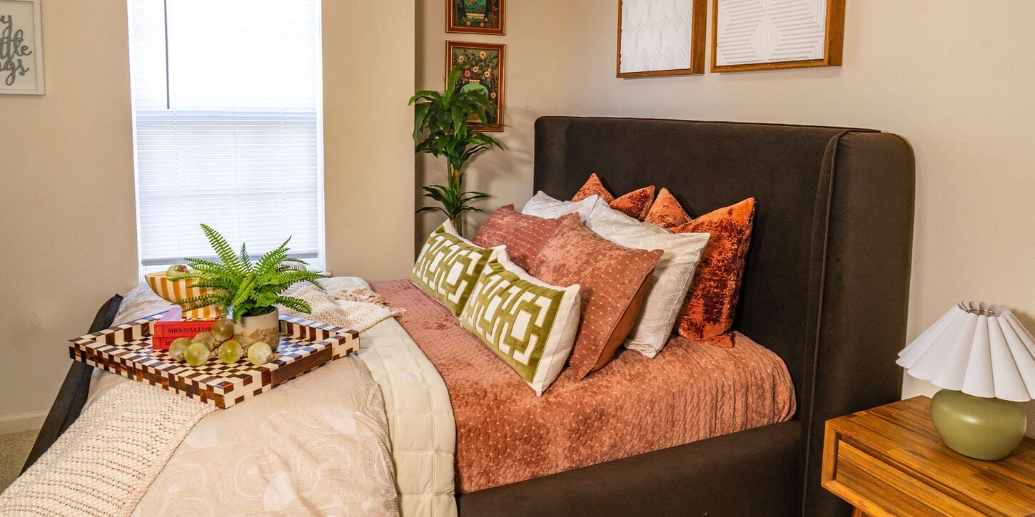 TyJanae's bedroom collection for 37B with a bed, side table, lamp and lots of decor