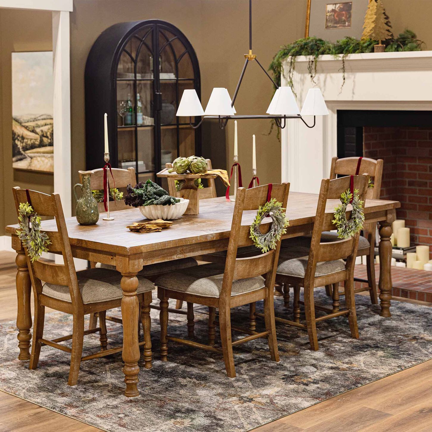 farmhouse dining set with holiday wreath on the back of chairs