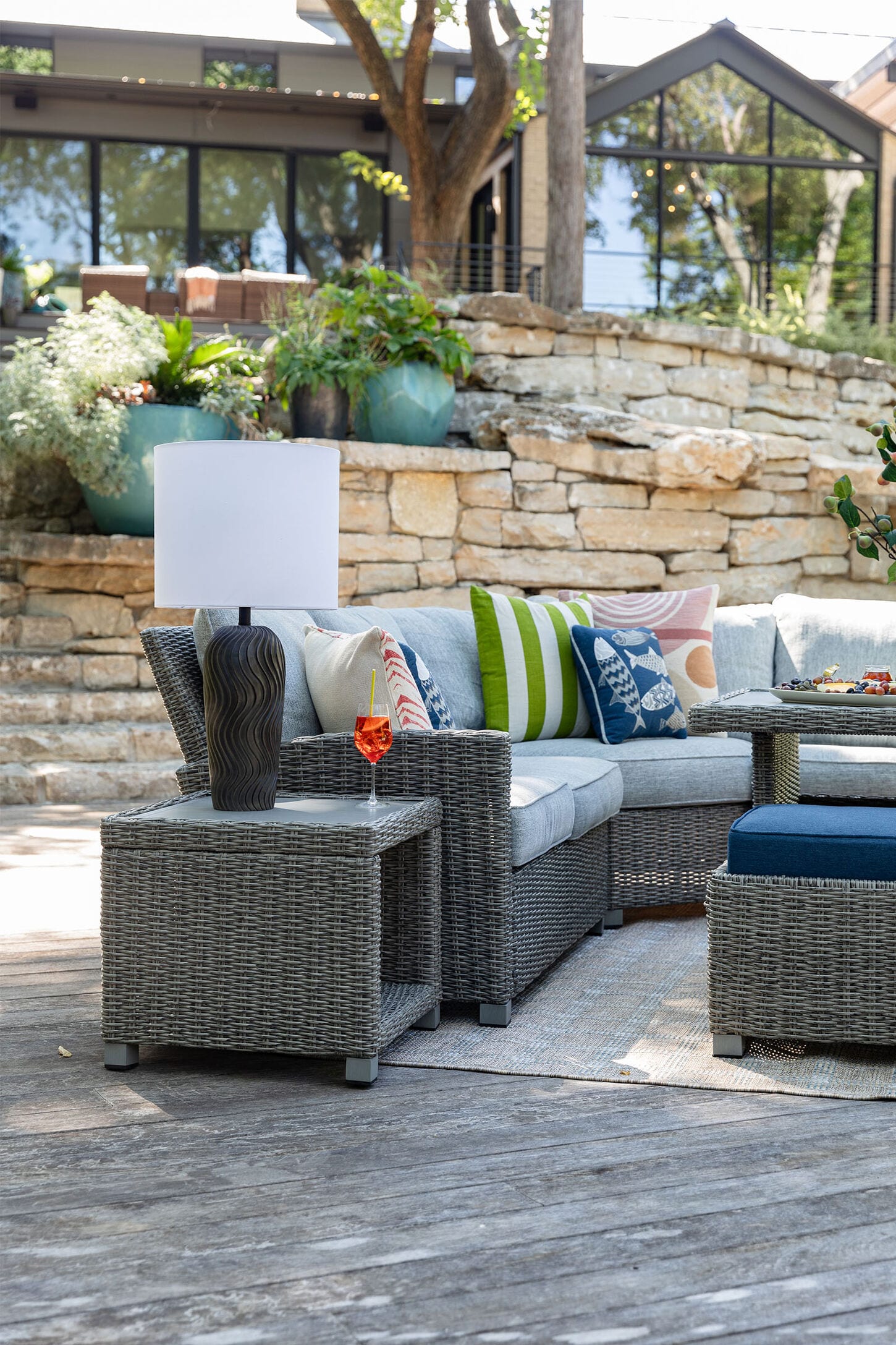 Spring patio furniture outside with lots of trees and greenery in the background
