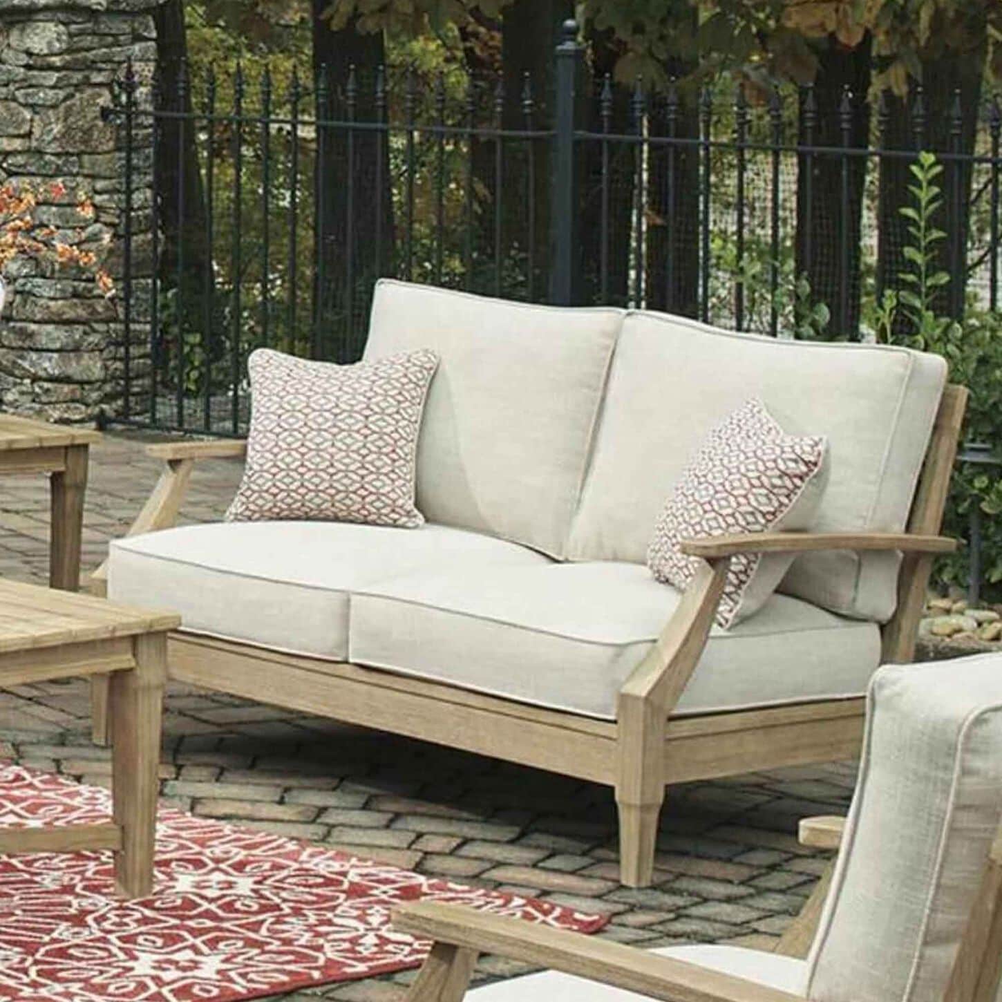 Ashley Clare View Loveseat with Beige Cushion in Antique Teak