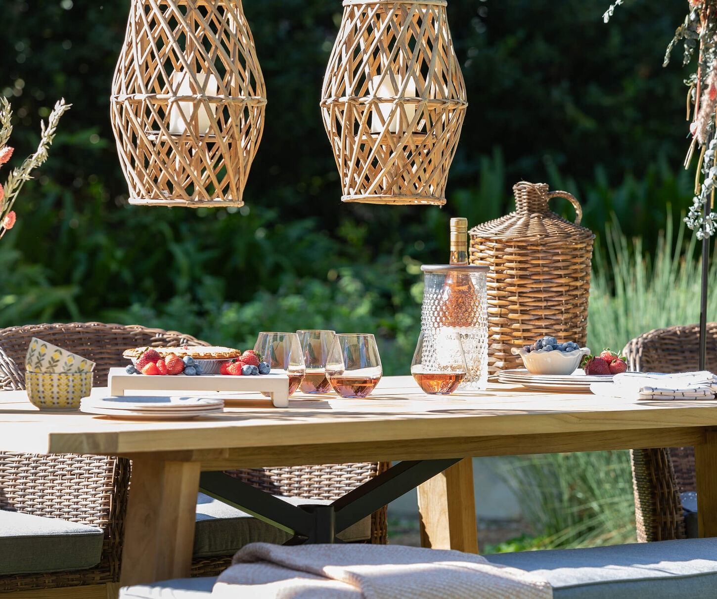 A beautiful patio dining set with wine and fruit for a dinner picnic.