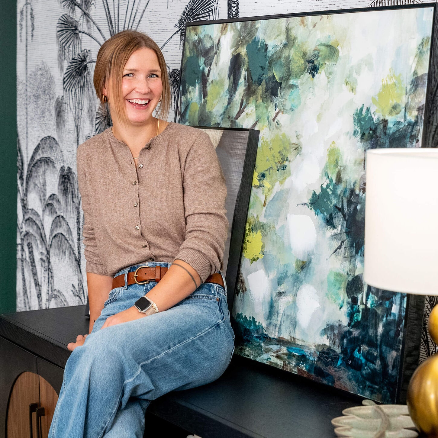 Sydney sitting on a credenza in the 37b limited drop living room