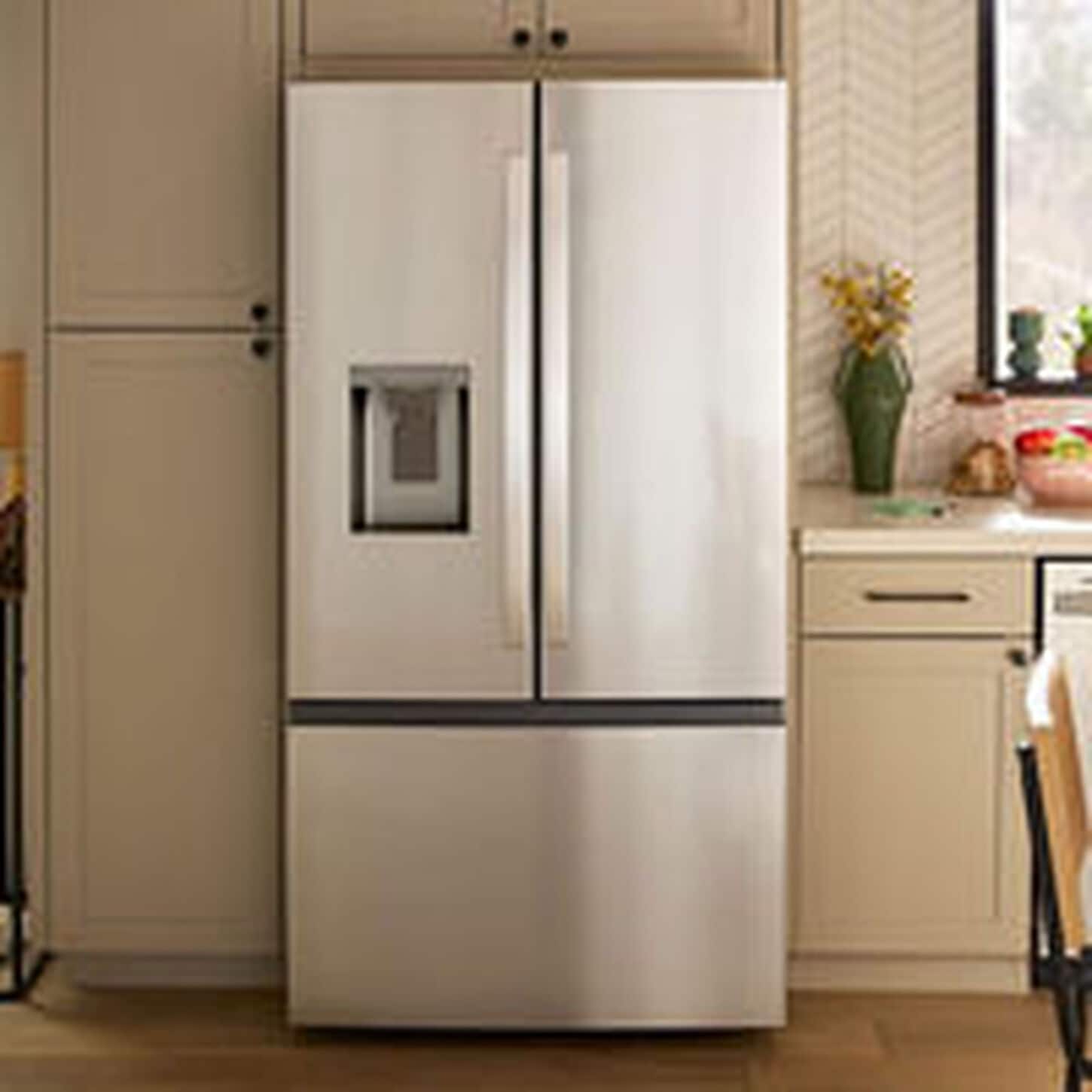 stainless steel refrigerator in a tan kitchen