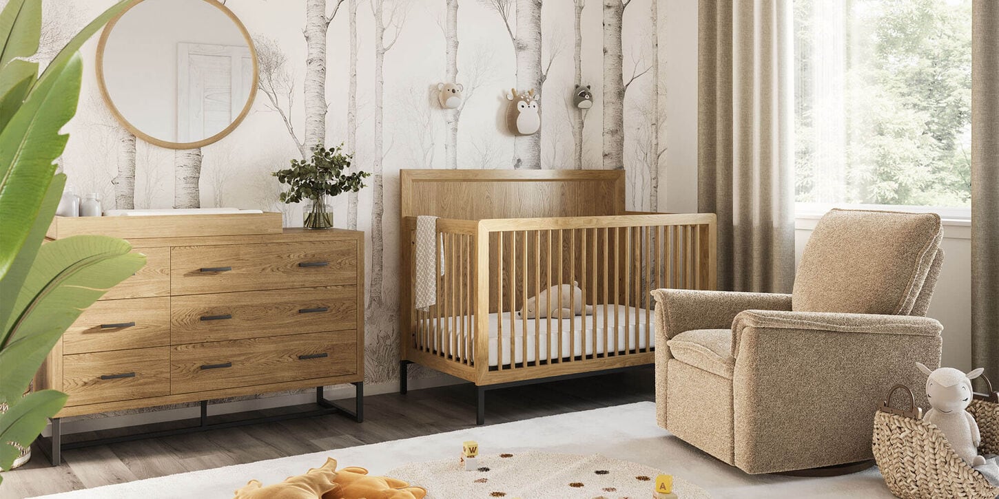 baby nursery with a crib, changing table, glider, and rug