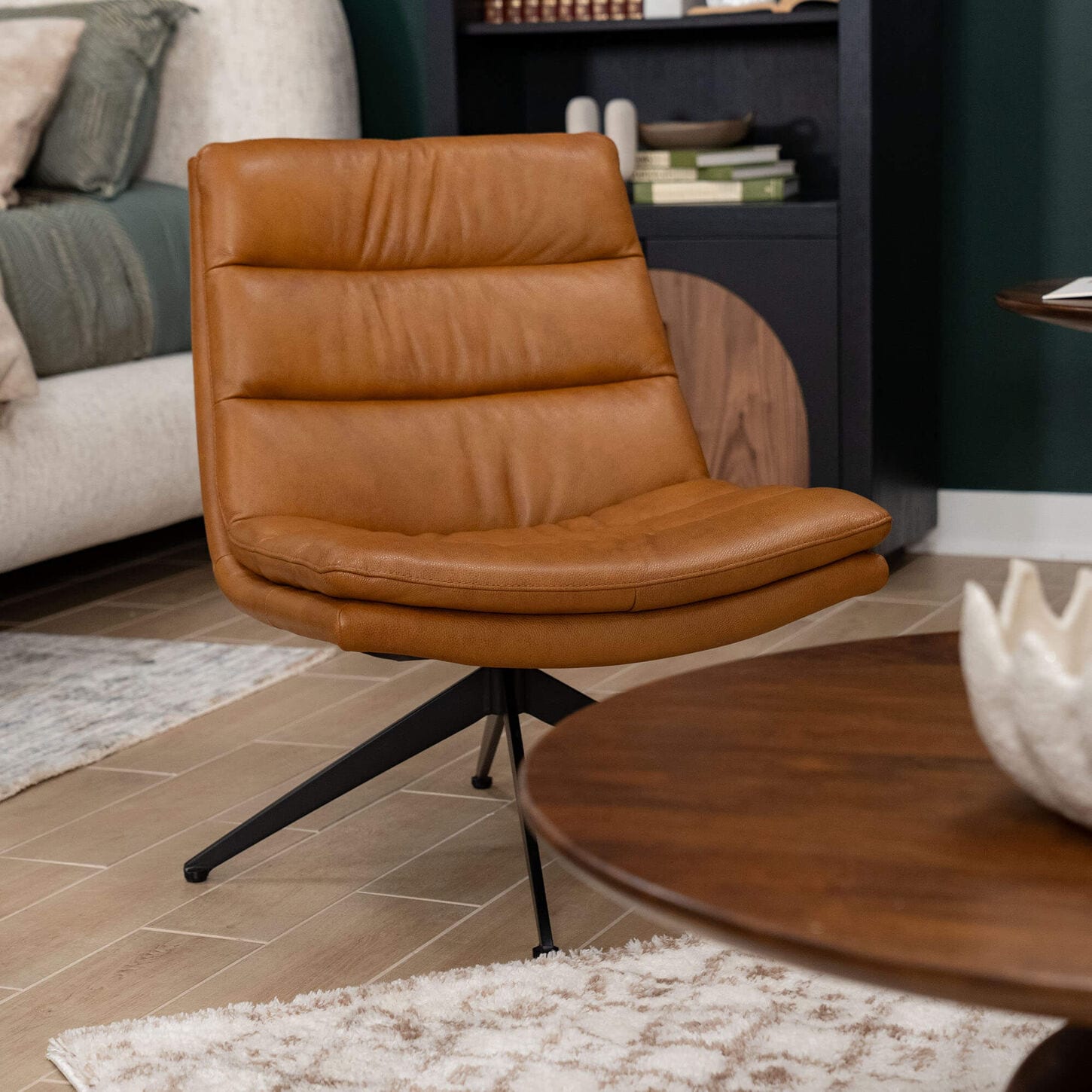 Brown leather chair next to a coffee table and rug