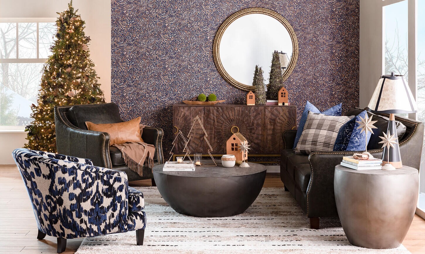 A Christmas themed living room with multiple places to sit including a Christmas tree in the left back corner. 