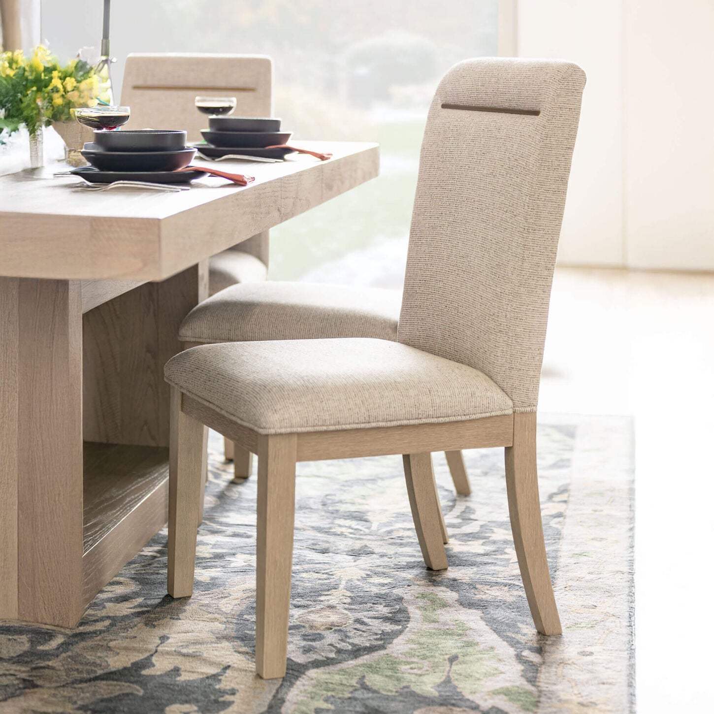 Upholstered dining side chair at a table