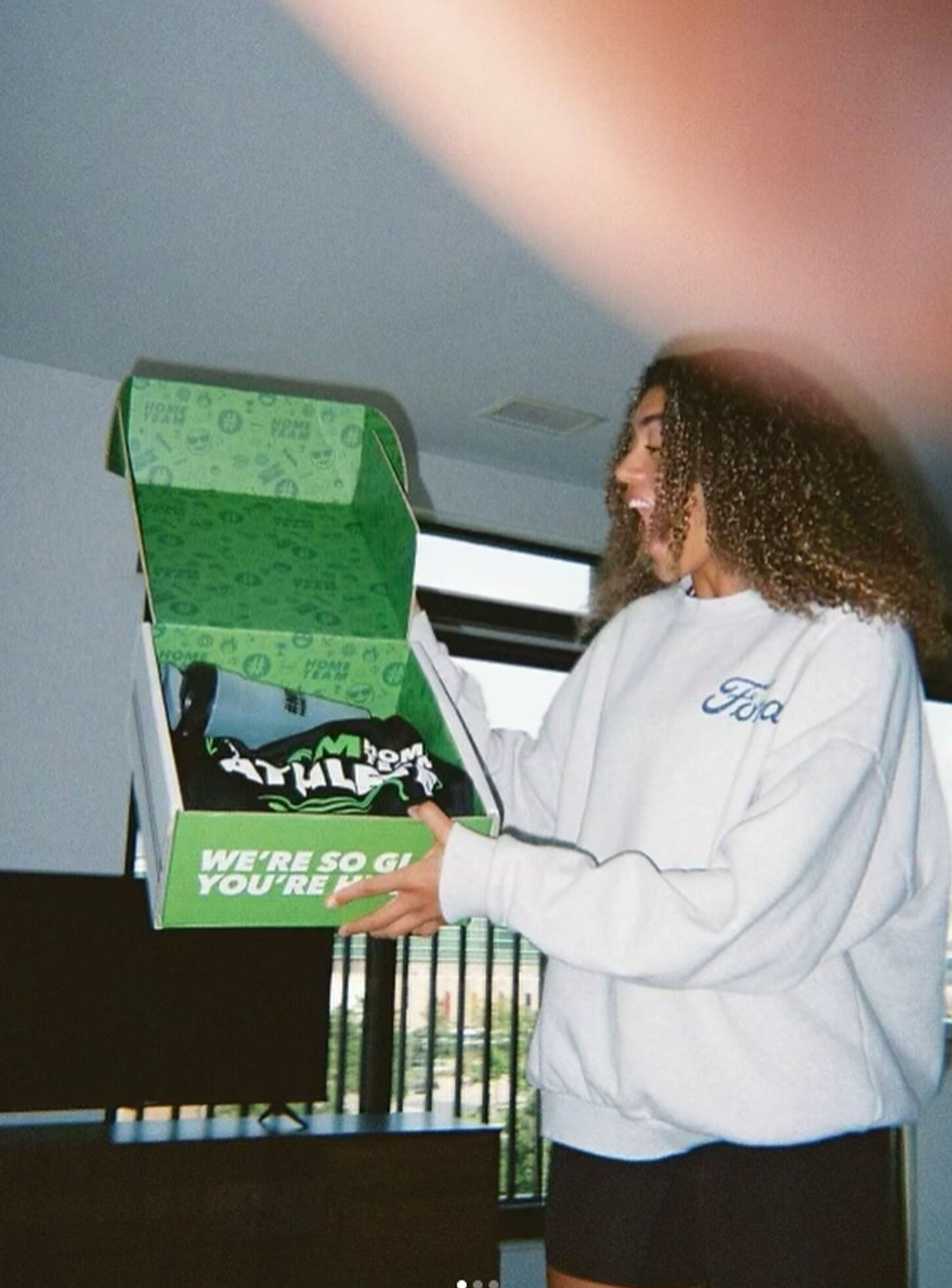 Home Team athlete posing for picture for welcome box