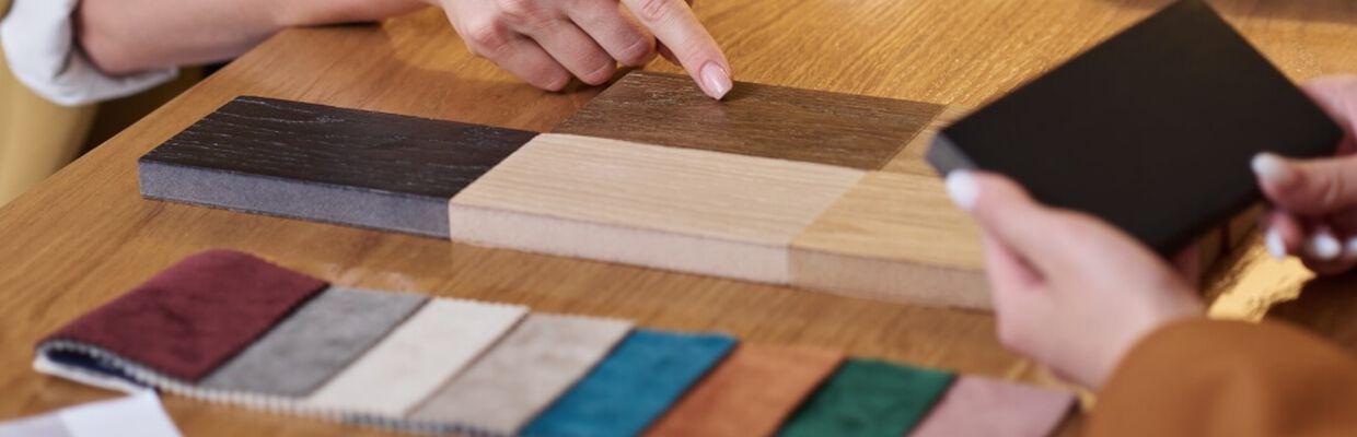 Two people at a table looking at fabric samples and swatches