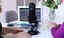 Two women sitting at table with computer and podcast microphone