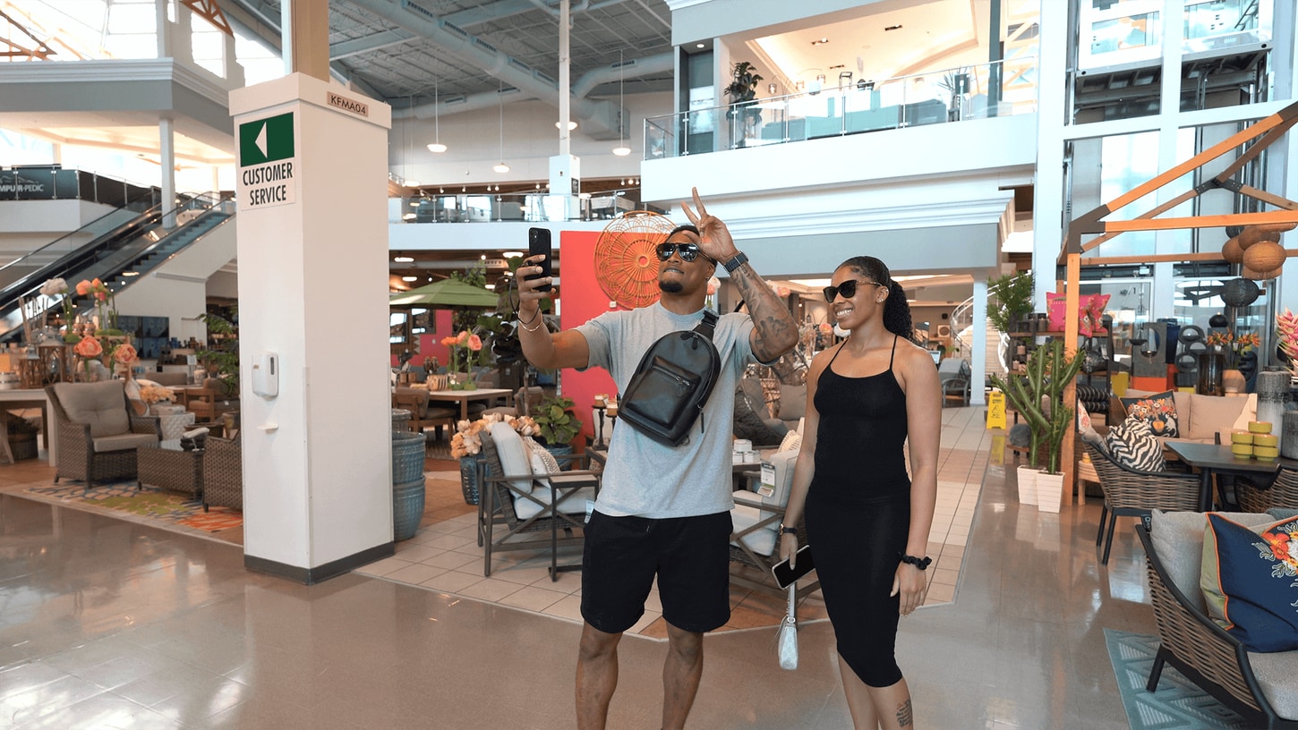 Bryan Cook and his girlfriend taking a selfie in front of the KC store