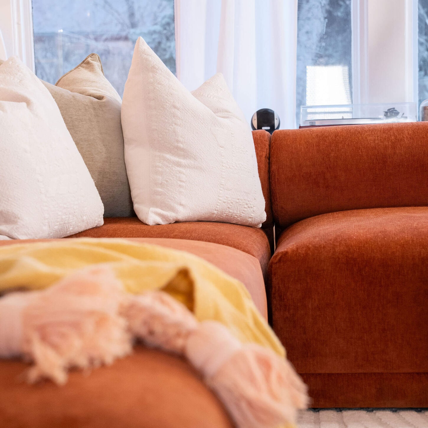 2 throw pillows and a blanket on a couch