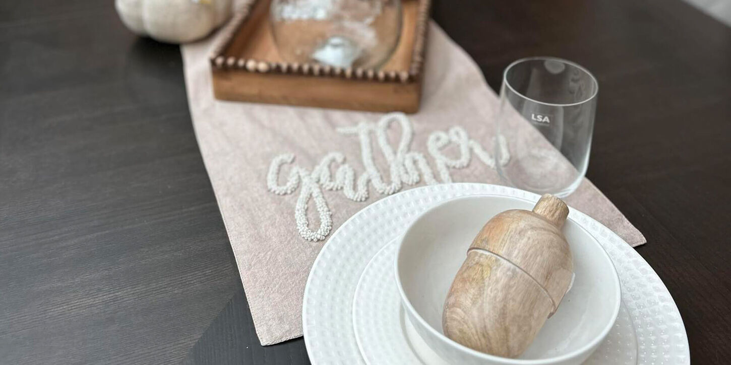 white place setting on a deep dark wood dining room table