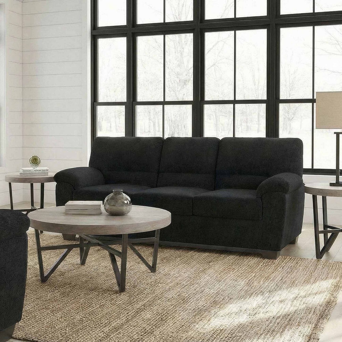 Living room featuring black sofa with gray living room table set