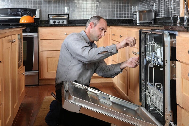 Contractor Working On Installing an Appliance
