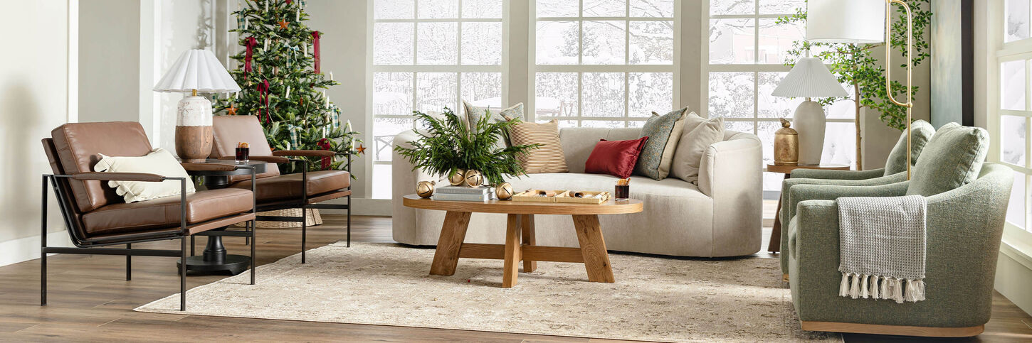 Christmas-decorated living room with snow falling outside