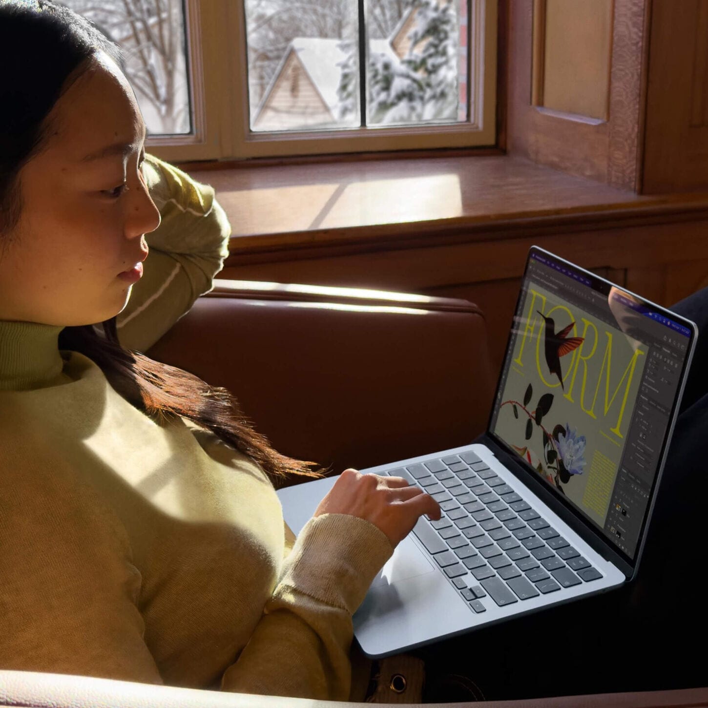 Person sitting with Apple laptop on lap