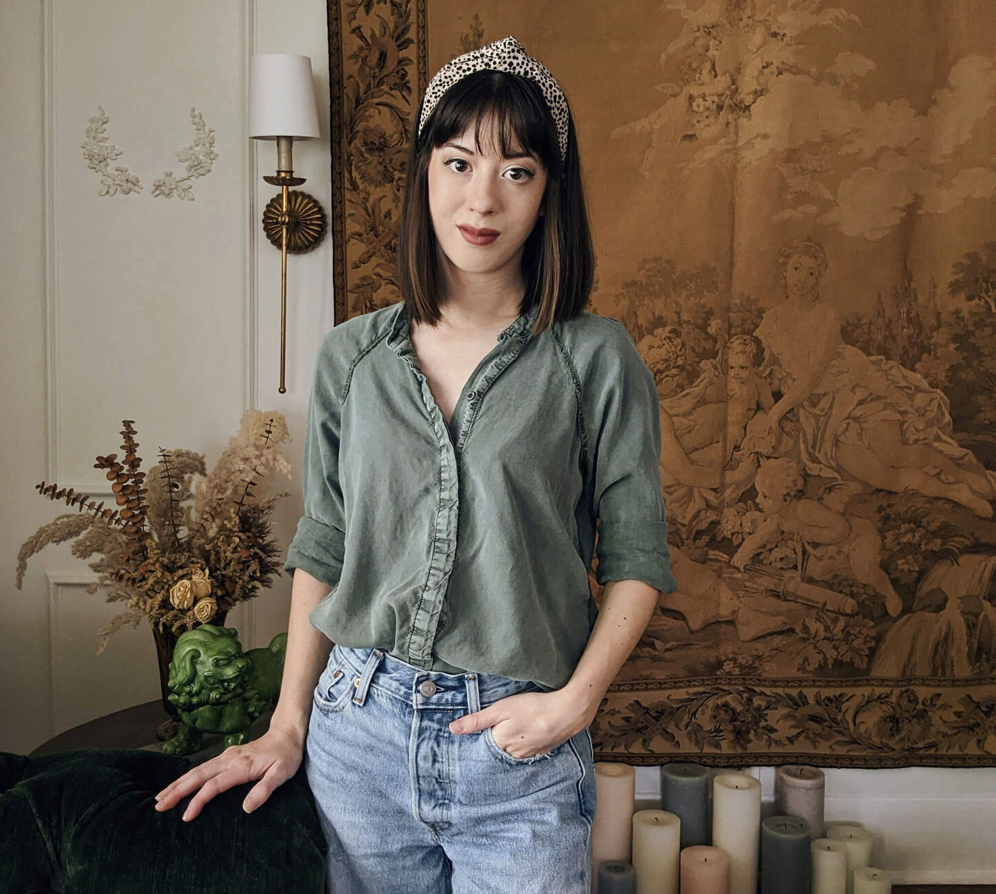Amanda Yong standing with one hand in her pocket in front of a tan background