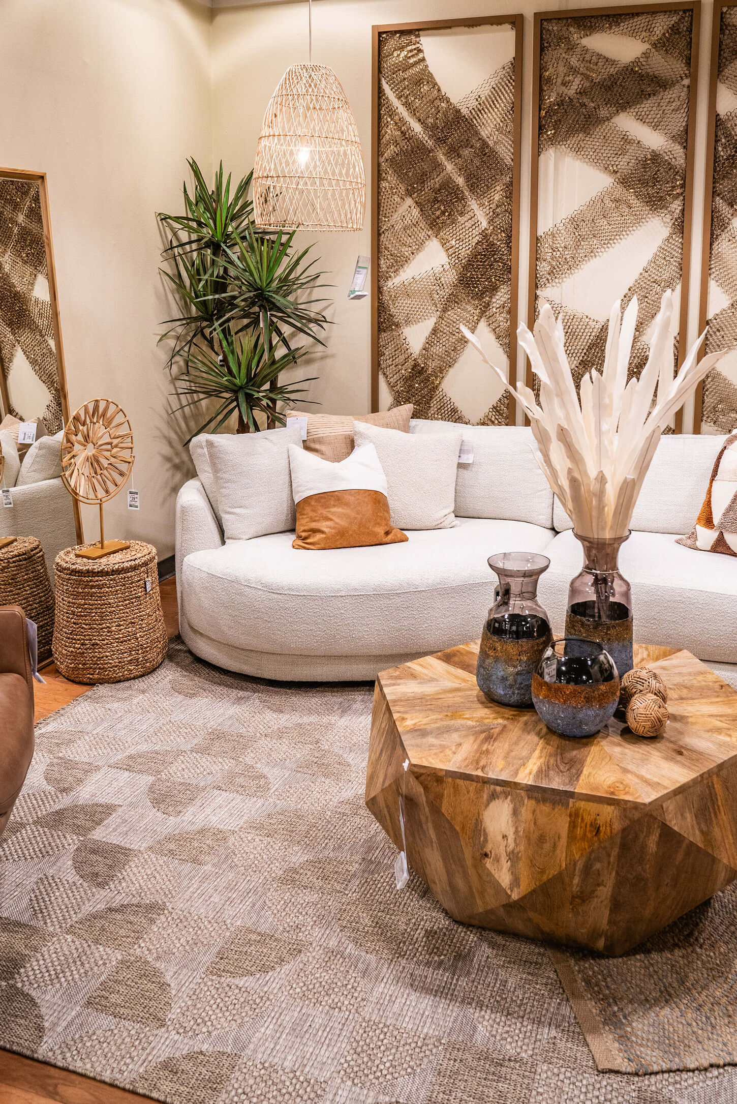 Home office with a desk, chair, desktop computer, plant and lots of paintings and artwork in the background on the wall