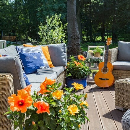Outdoor patio furniture with flowers all around