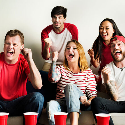 Group of friends cheering on their sports team