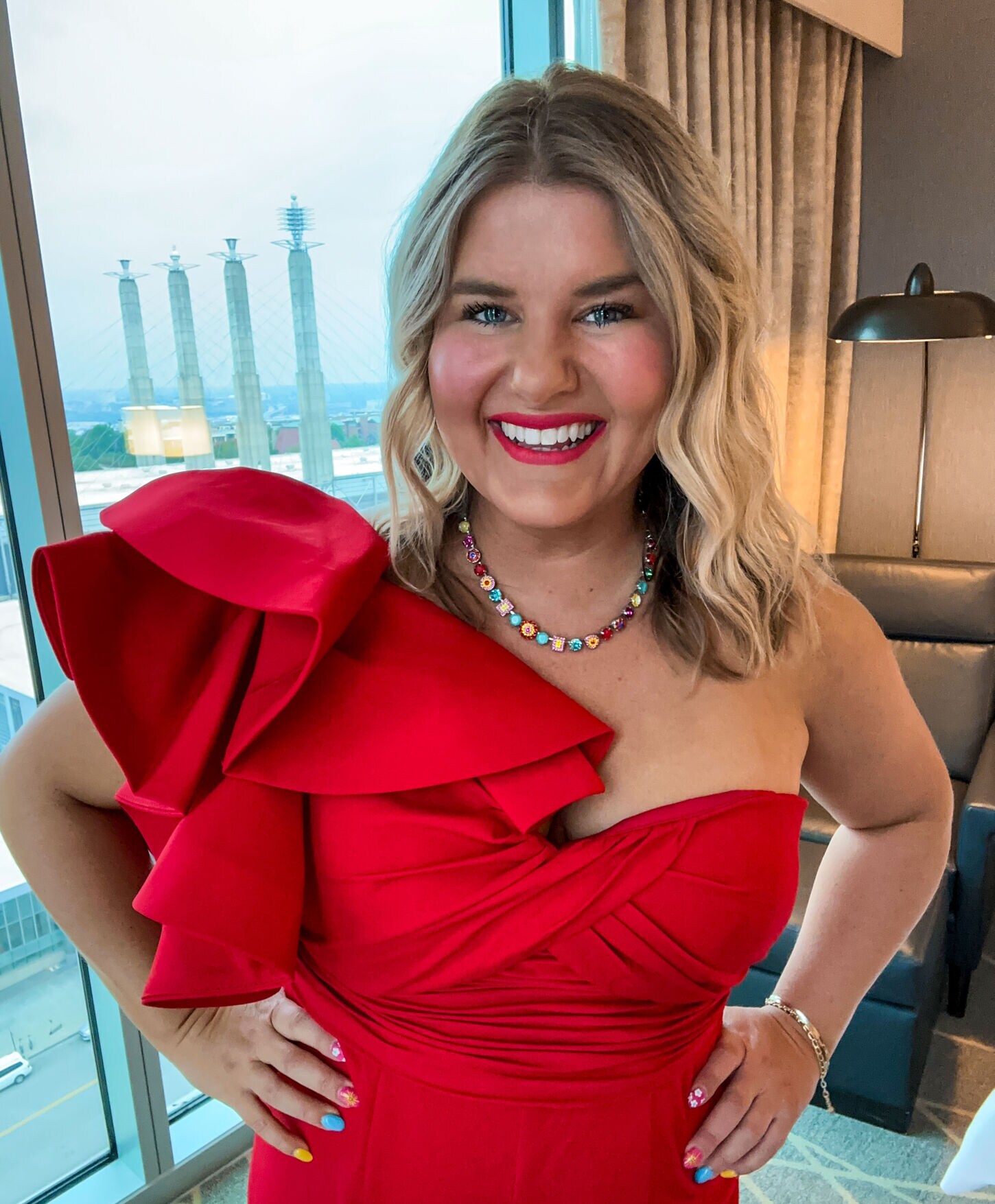 Influencer Molly Kuplen posing in a red dress