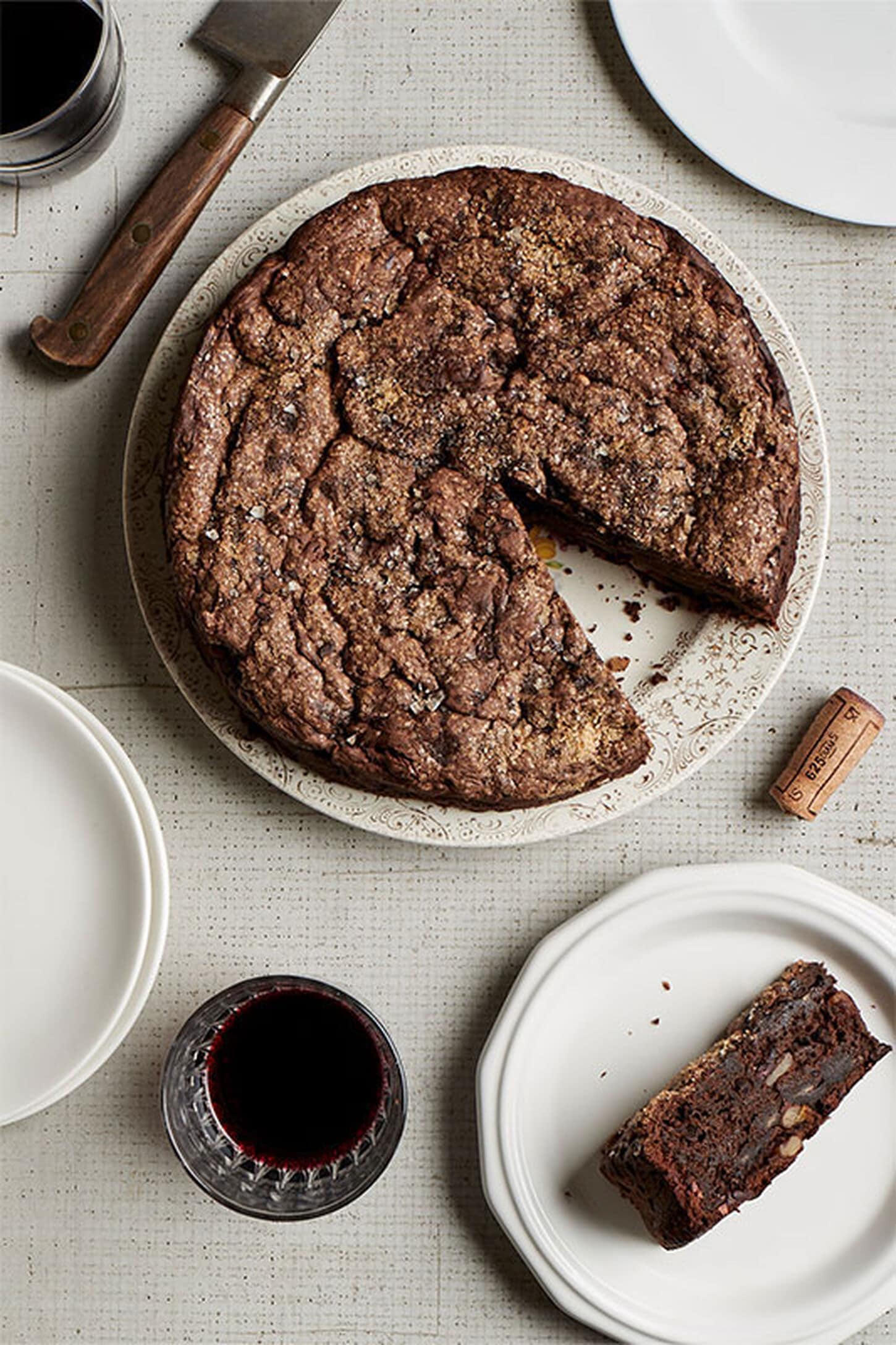A cut pie with a sliced piece on a plate