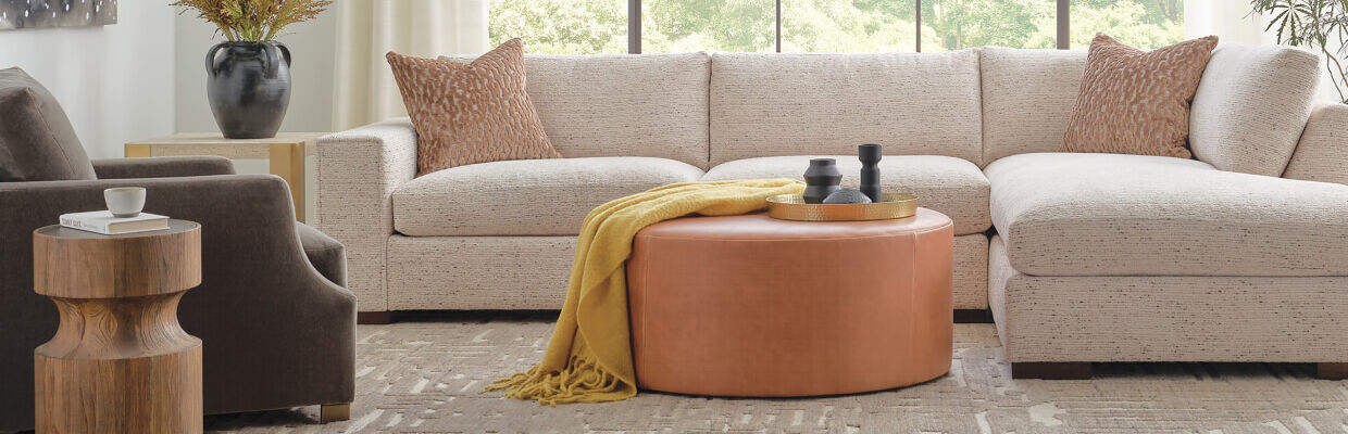 Living room with stylish neutral colored sofa and other decor