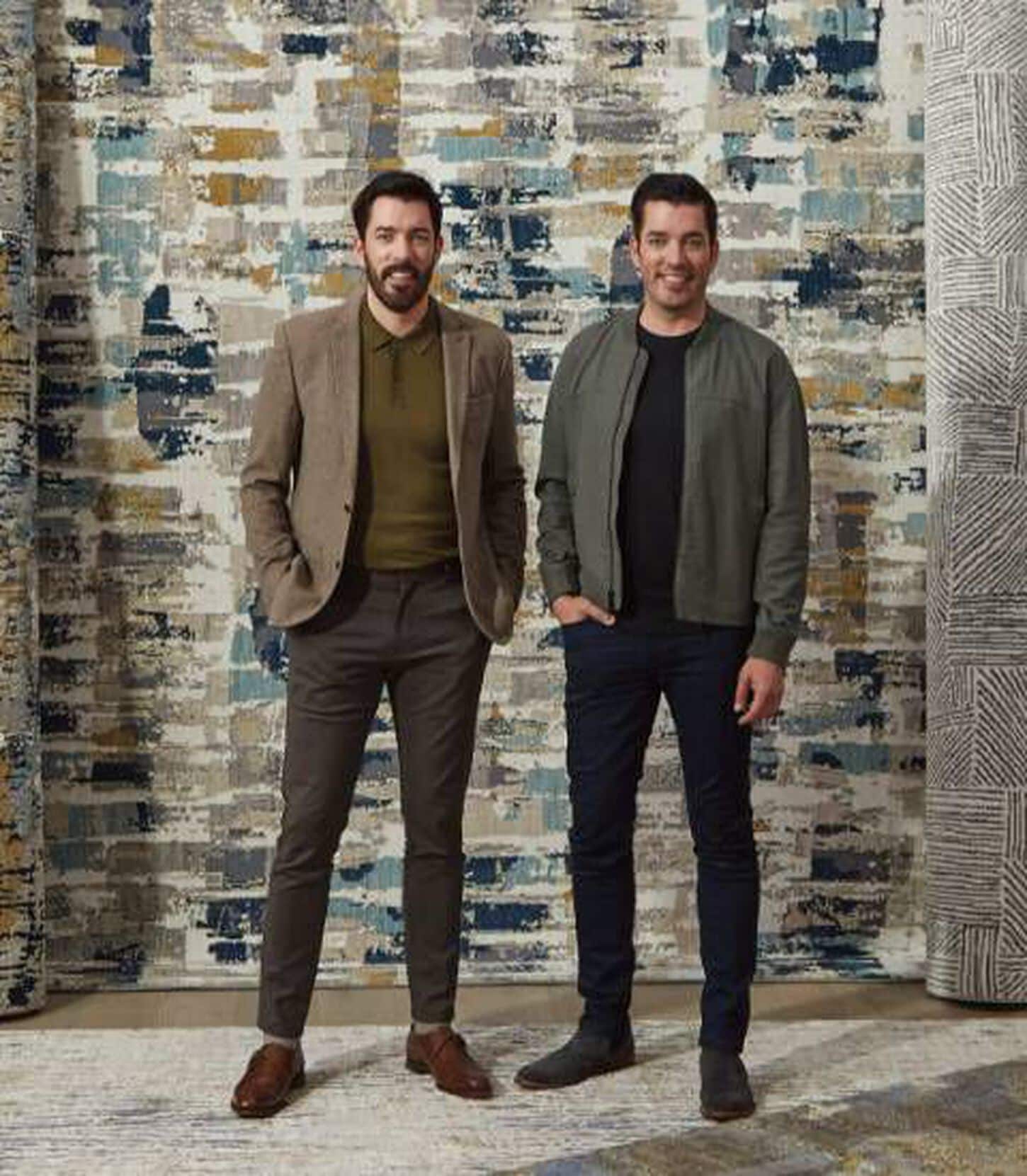 Scott Brothers posing near their designer rugs