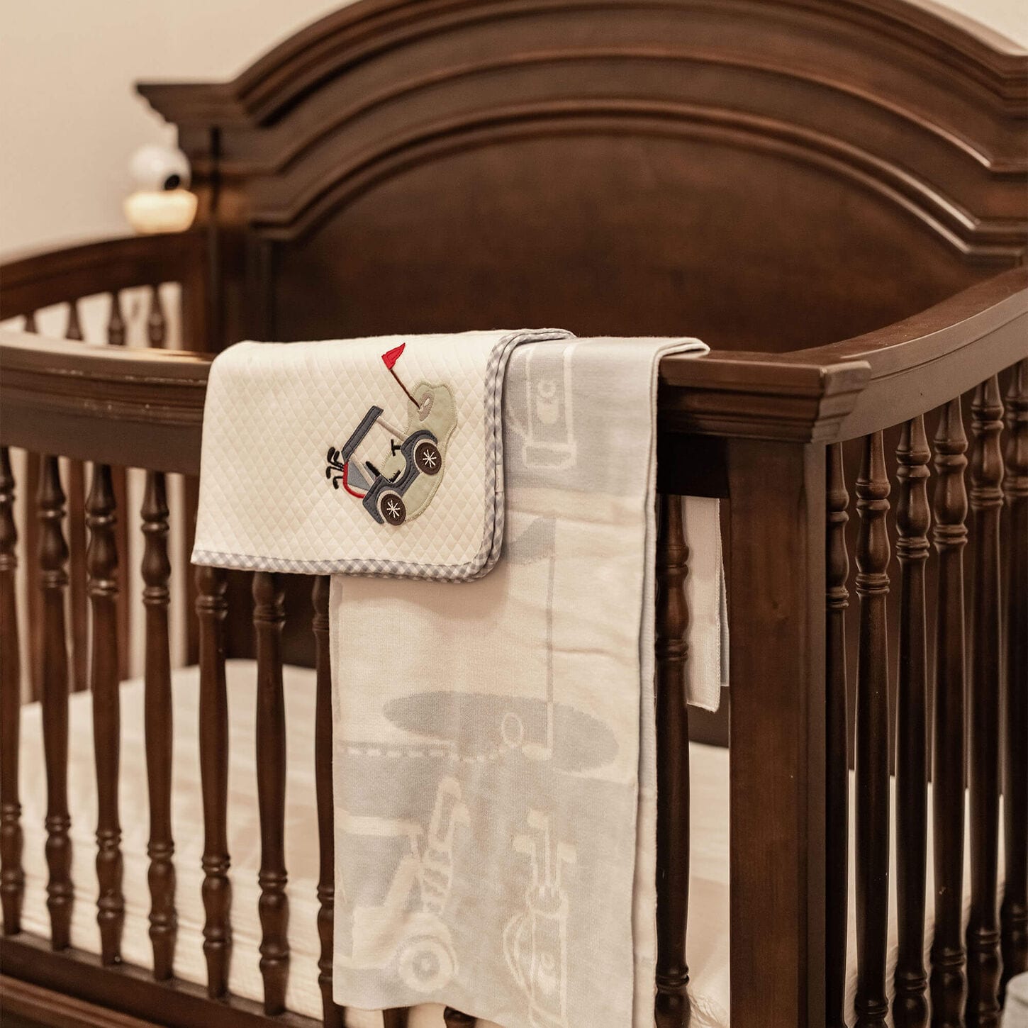 shelby's nursery showing the crib, baby blankets, and a rocker