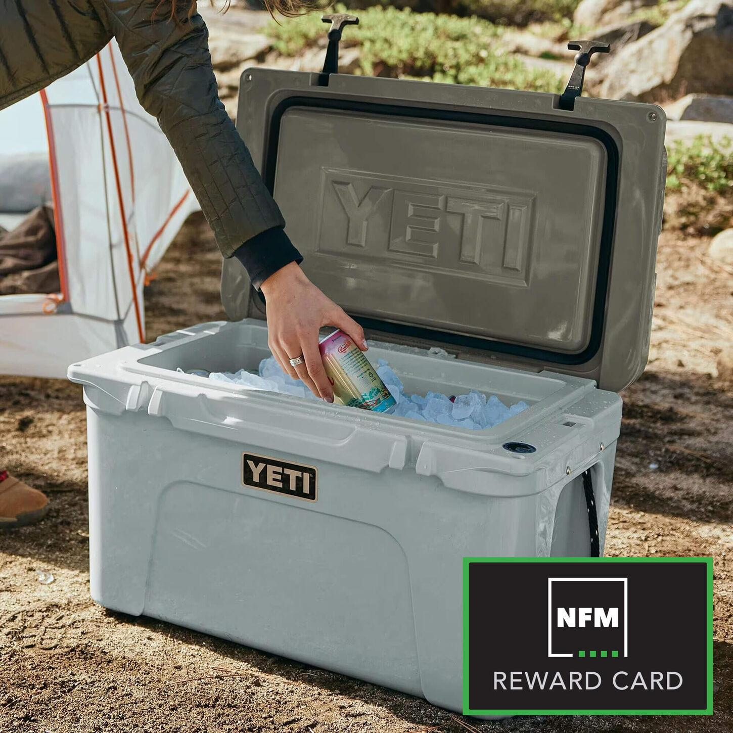 YETI Tundra 45 Hard Cooler in Ridgeline with an arm reaching in to the cooler filled with ice