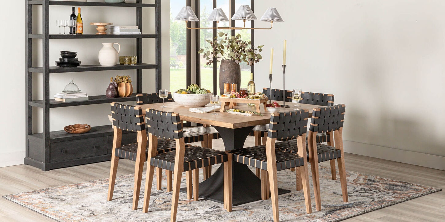 Dining room with a table set and book shelf full of decor