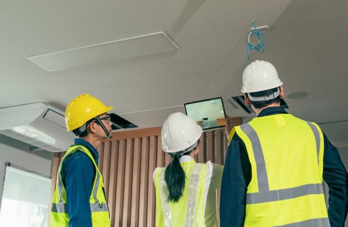 Workers gathered to test newly installed wiring and technology at business