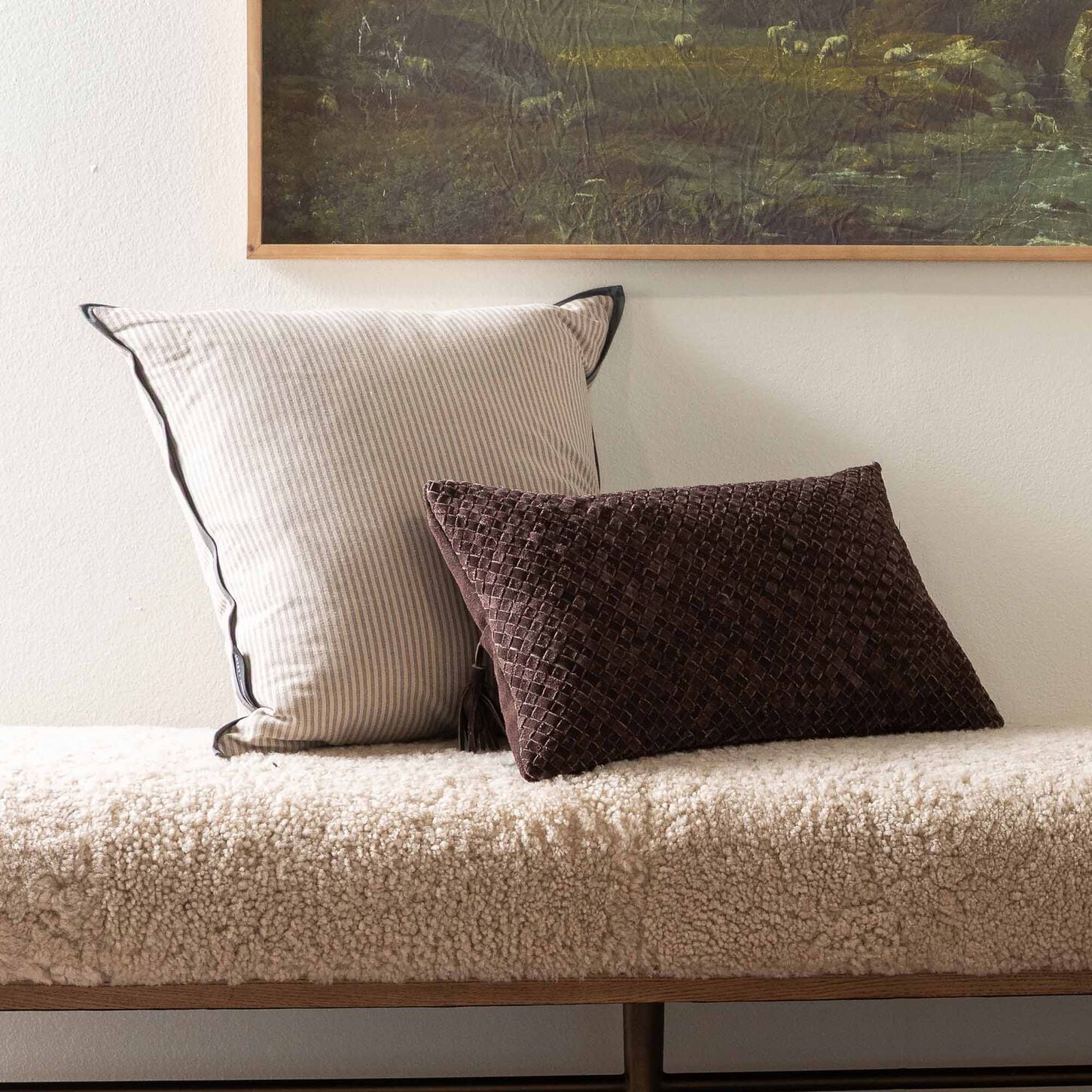 Brown and tan throw pillows resting on a bench