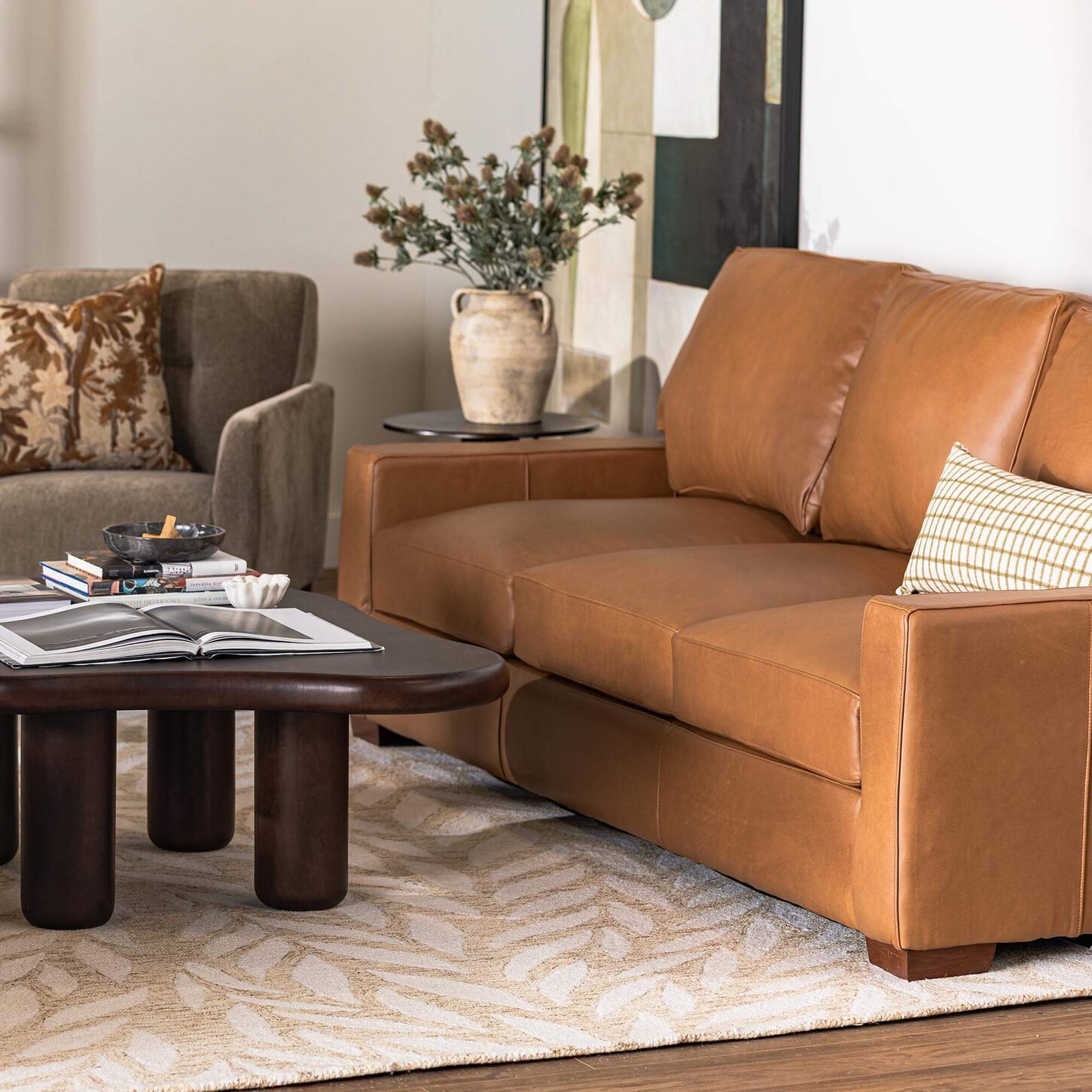 Light brown leather sofa with a dark coffee table in a cozy room