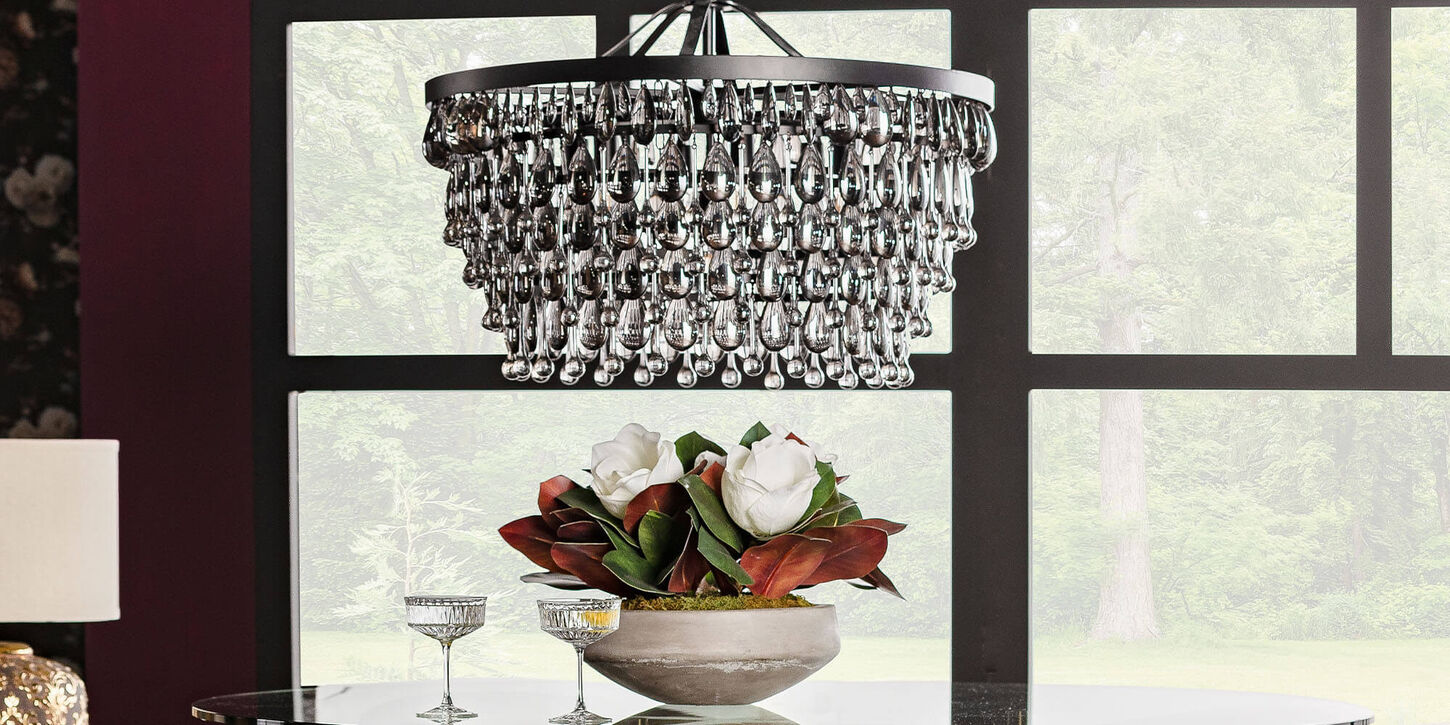 Black chandelier above dining table with big windows and purple walls