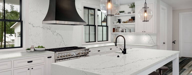 Kitchen with white, gray, and black color scheme and light countertops