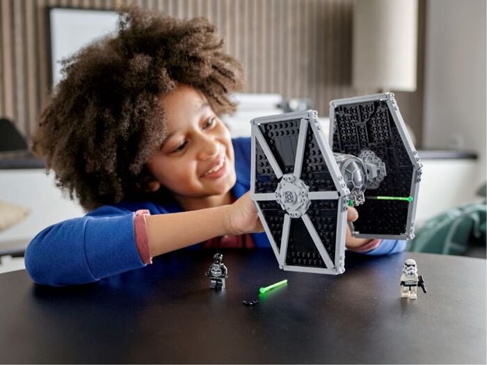 Kid playing with star wars legos