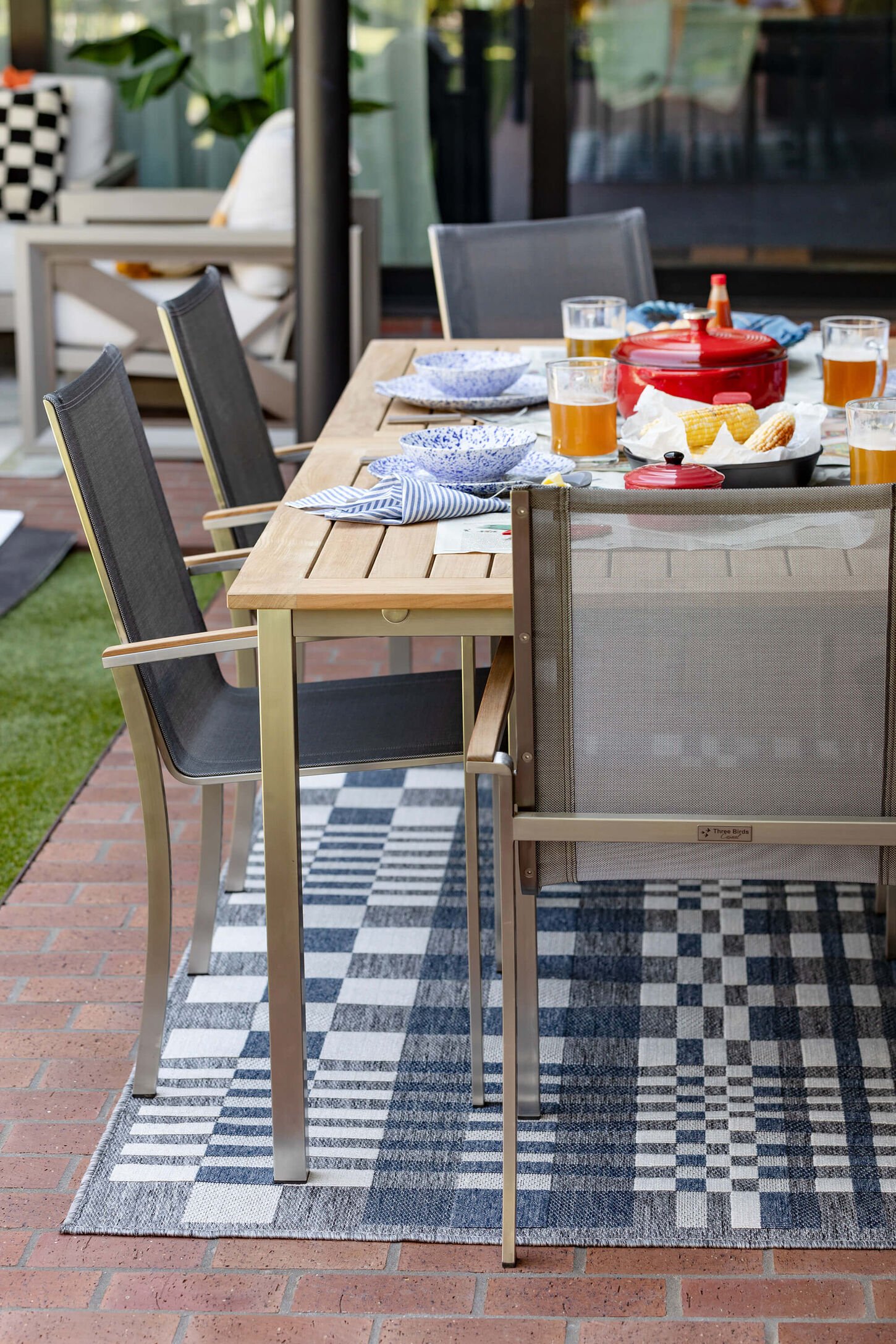 Outdoor rugs underneath a dining table.
