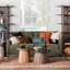 A stylish living room featuring a green sofa and decorative pillows.