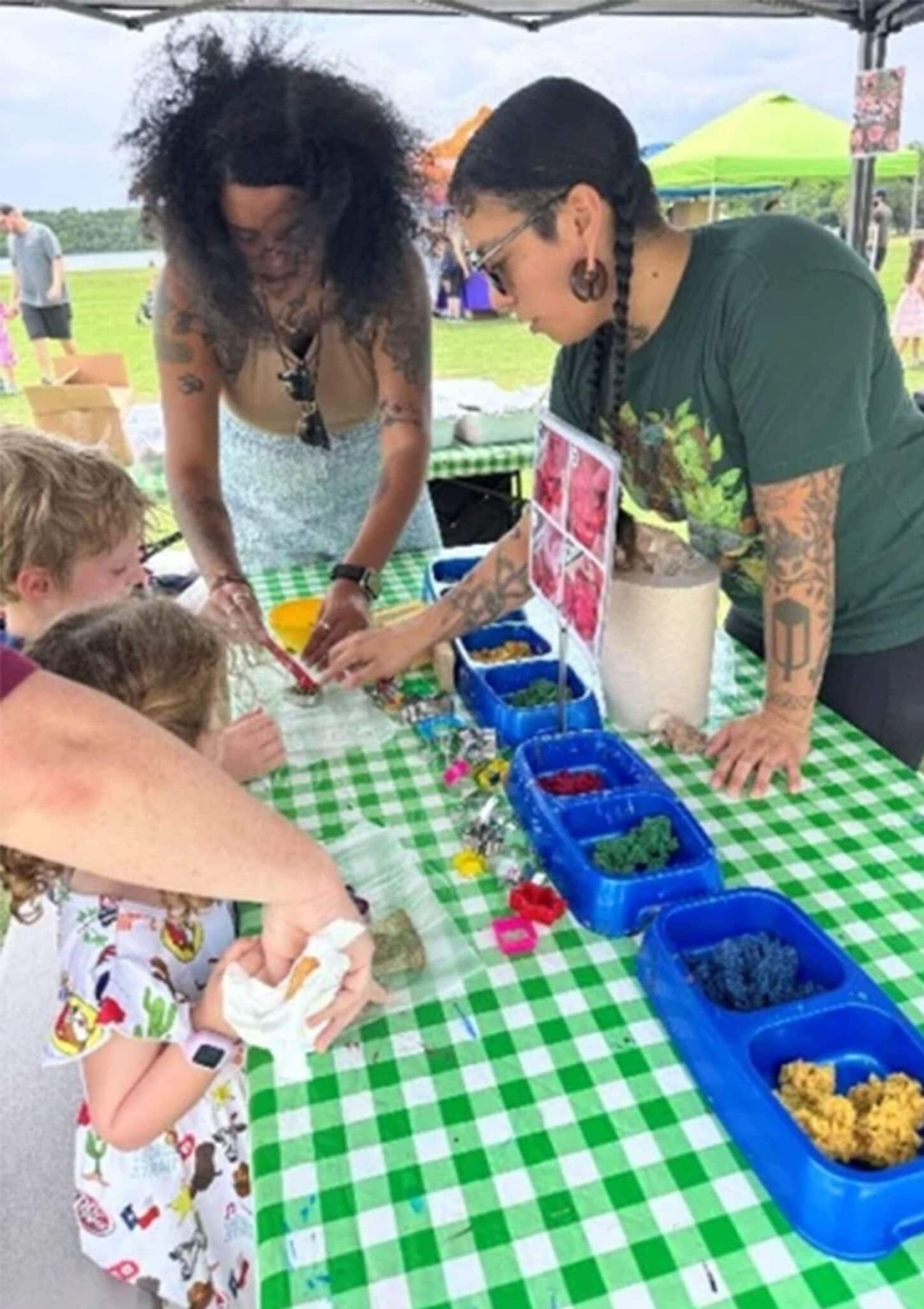 Cedar Park Earth Day event with women planting flowers on table