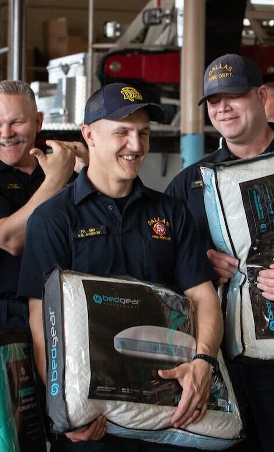 Dallas Texas Firefighters holding new Bedgear pillows provided by NFM.